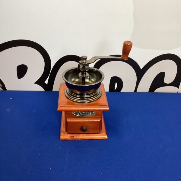 Antique Kaffe coffee grinder with wooden hopper and cast iron base.