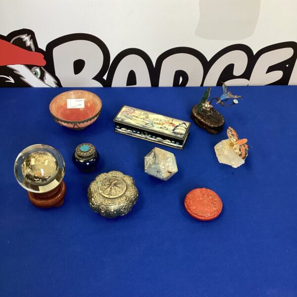 Selection of oriental trinket pots, enamel bird and lacquered box on display.