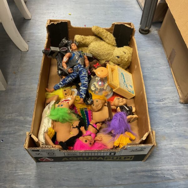 Vintage toy lot featuring colourful troll dolls and plastic figures.
