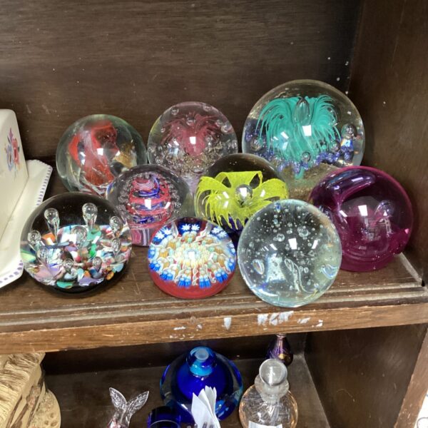 Vibrant glass paperweights displayed as a collectible selection.