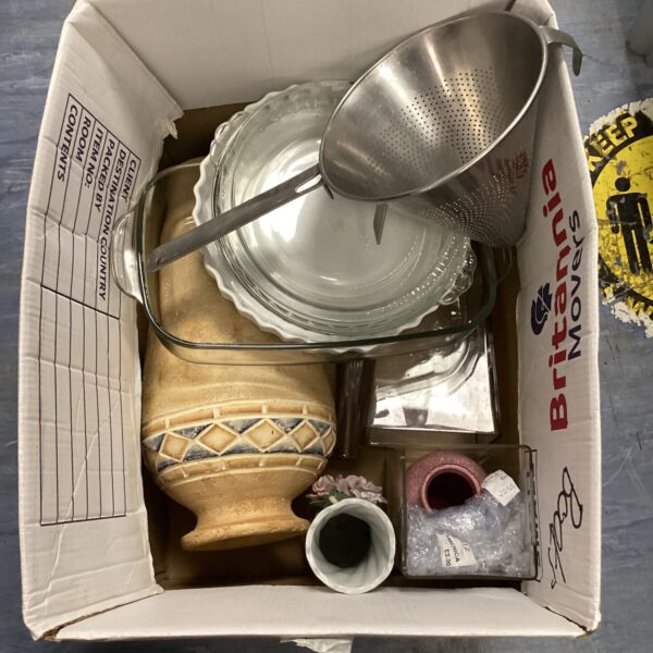 Vintage kitchenware lot with metal pots and pans.