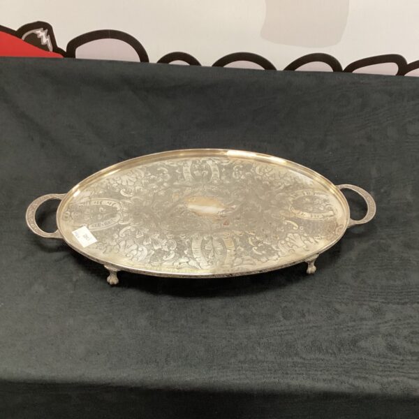 Ornate vintage silverplate serving tray with embossed detailing.