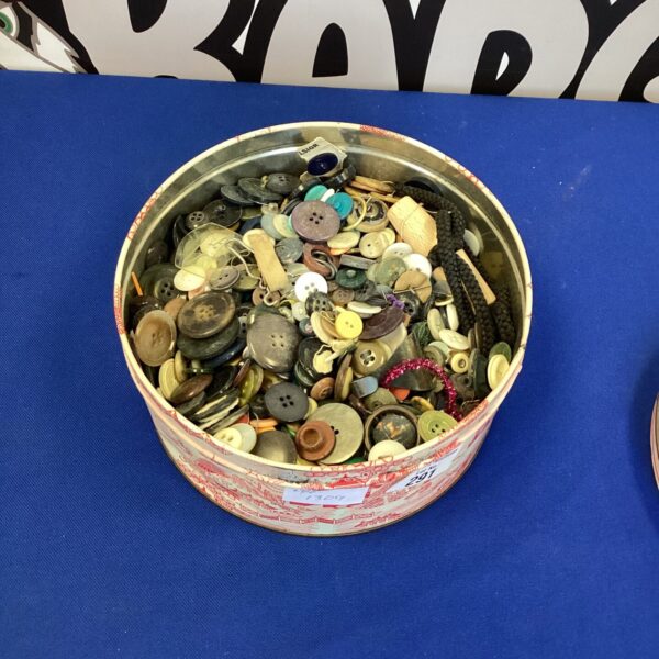 Close-up of a tin filled with vintage buttons.