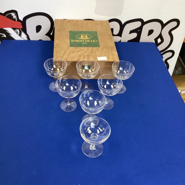 Elegant crystal champagne glasses in a wooden presentation box.