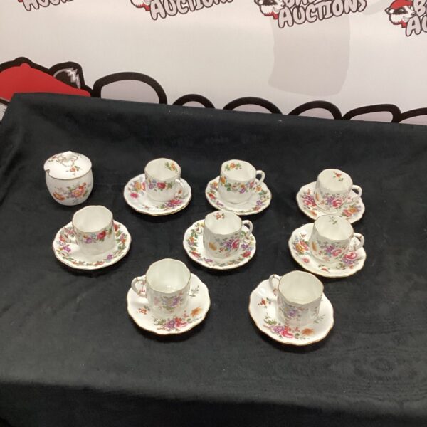 Vintage Royal Crown Derby tea cups with floral design.