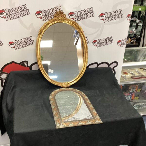 Vintage oval mirror with ornate gold frame for wall decor.