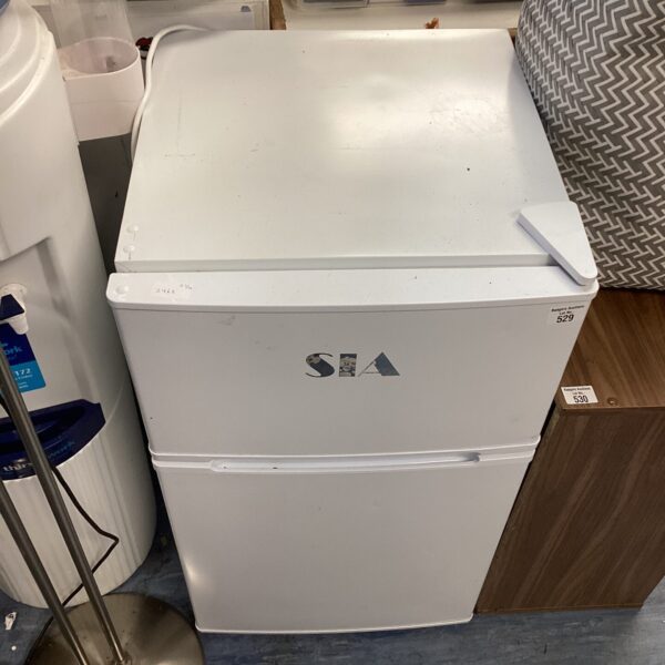 White SIA fridge freezer, compact kitchen appliance for food storage.