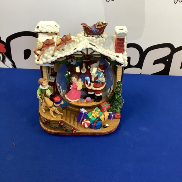 Detailed porcelain Christmas village ornament with Santa Claus.