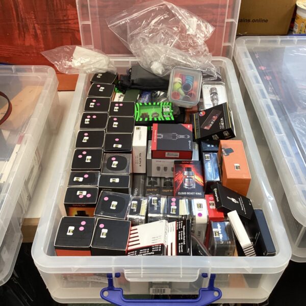 Box of assorted vaping rigs and mods for sale.