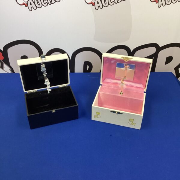 Black vintage musical jewellery box with open lid.