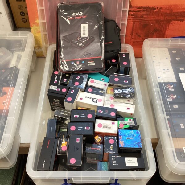 Vaping mods and accessories lot with coil master bags.