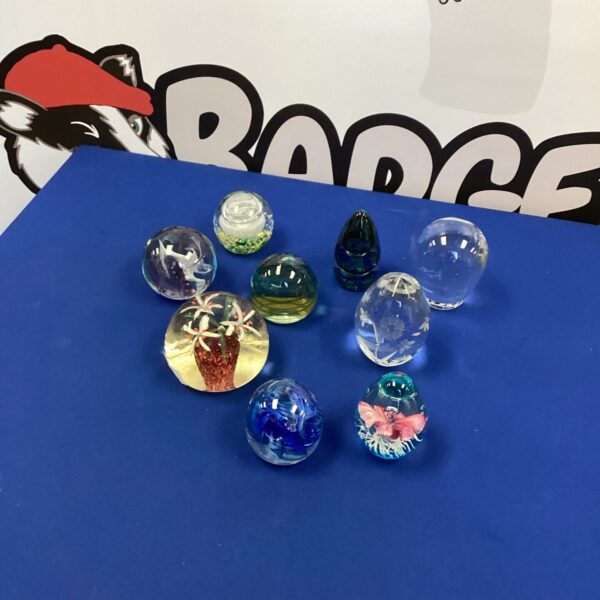 Colourful glass paperweights selection for collectors and desk display.