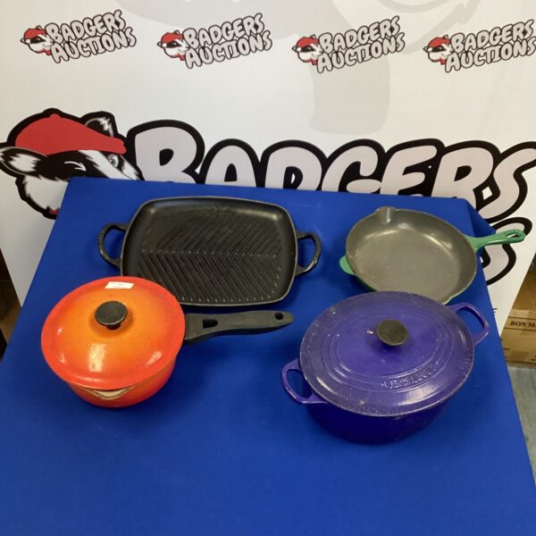 Vibrant Le Creuset kitchenware set including casserole dish and skillet.