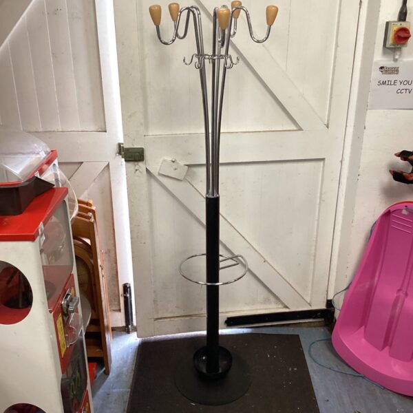 Black and chrome coat and umbrella stand in a hallway.