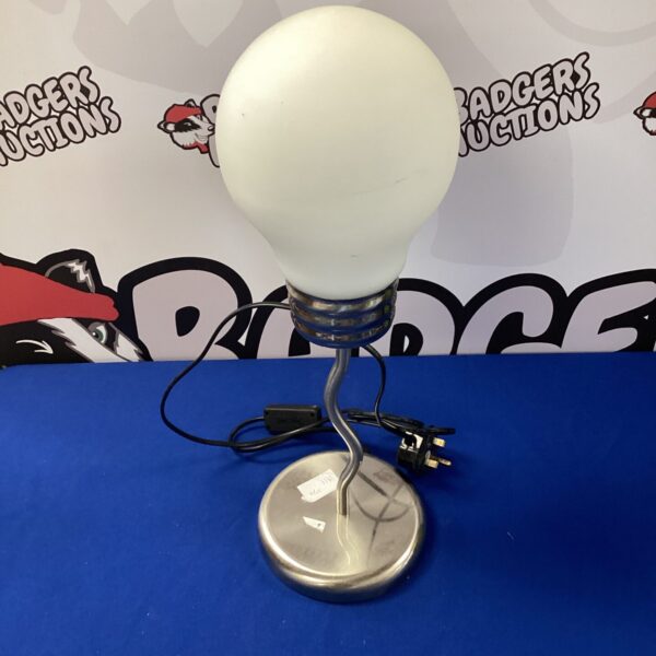 Modern chrome desk lamp with adjustable head for task lighting.