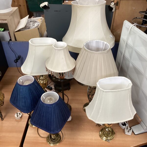 Eight vintage table lamps with brass bases, ideal for collectors.