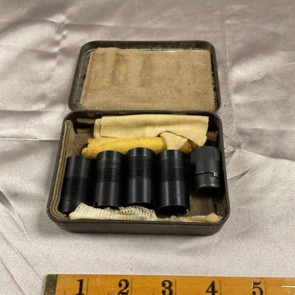 Tin of 12 bore shotgun chokes for clay pigeon shooting.