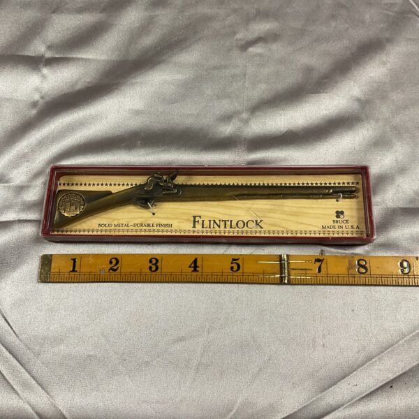 Detailed solid metal flintlock pistol model replica for collectors.