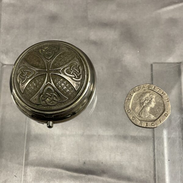 Antique silver pill pot with Celtic knotwork design.