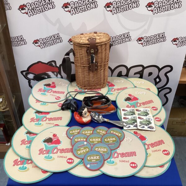Vintage ice cream parlour memorabilia including placemats and a wine basket.