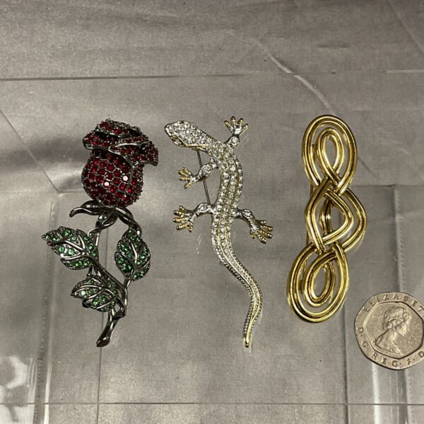 Detailed red and green stone set rose vintage brooch.