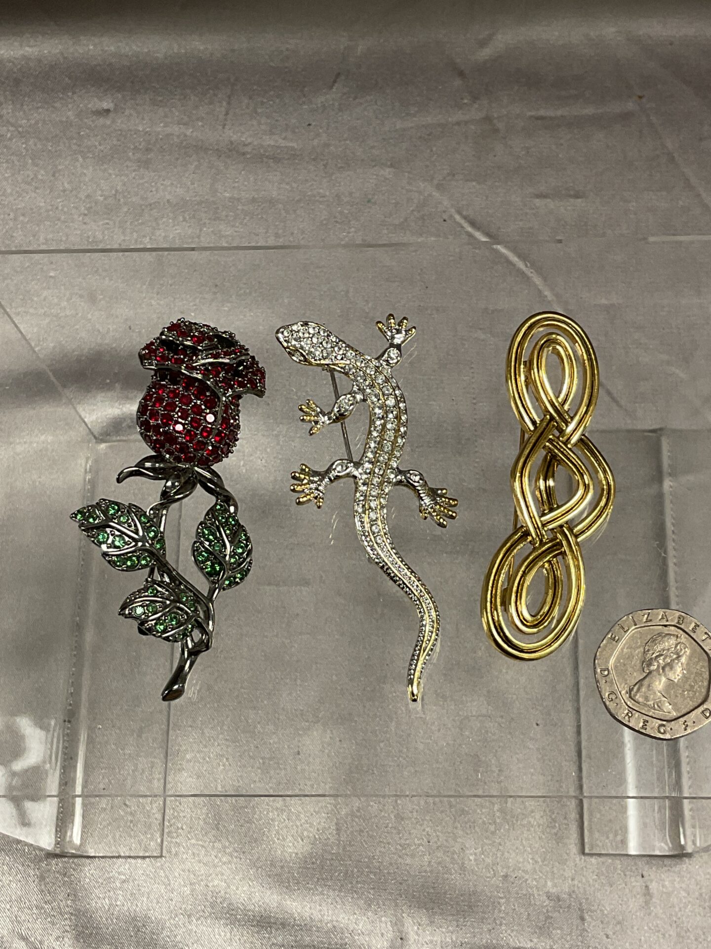823 Three Brooches inc red and green stone set rose