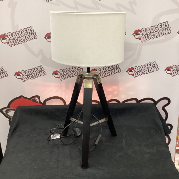 Vintage wooden tripod lamp with adjustable shade.