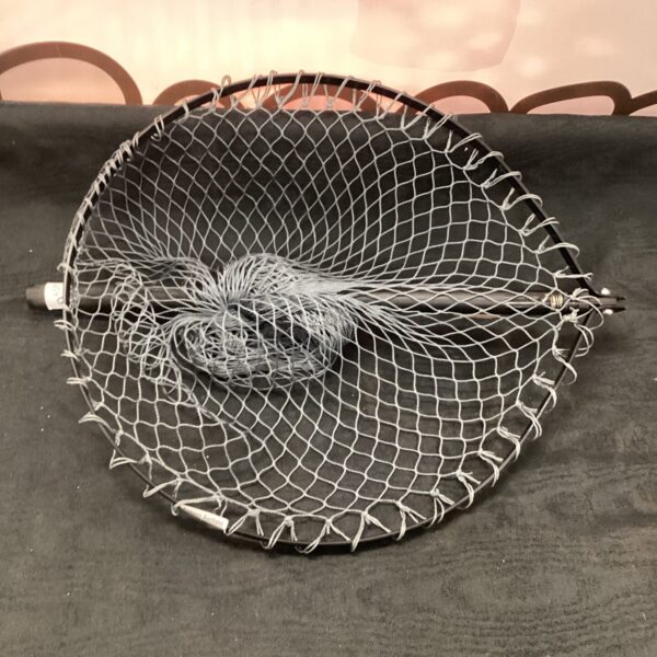 Vintage fly fishing net with dark mesh for trout.