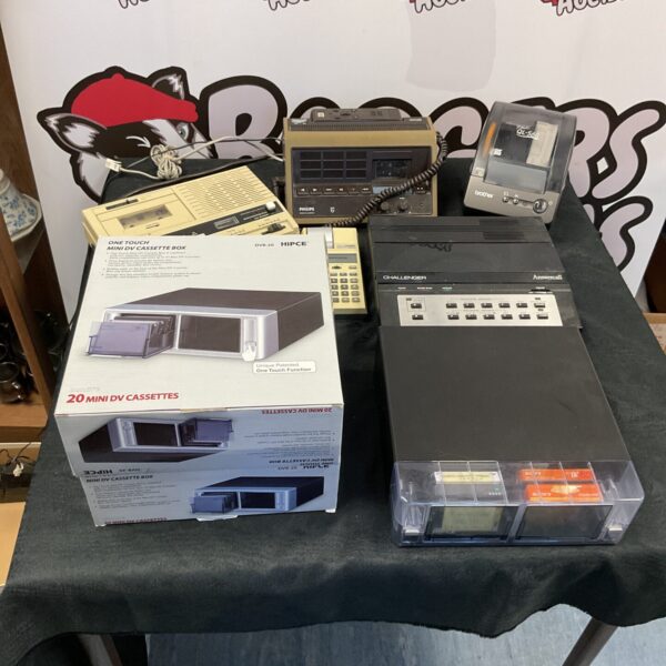 Vintage dictaphone lot with label printer and cassettes.