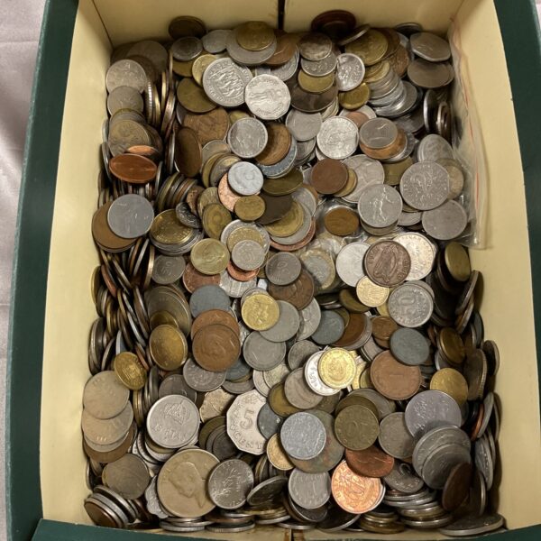 Bulk assortment of vintage and modern coins in a cardboard box.
