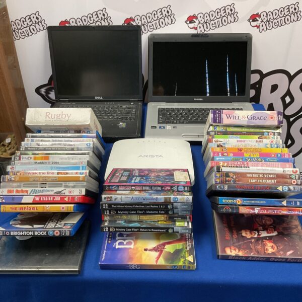 Vintage laptops and DVD collection, including Toshiba and Dell models.
