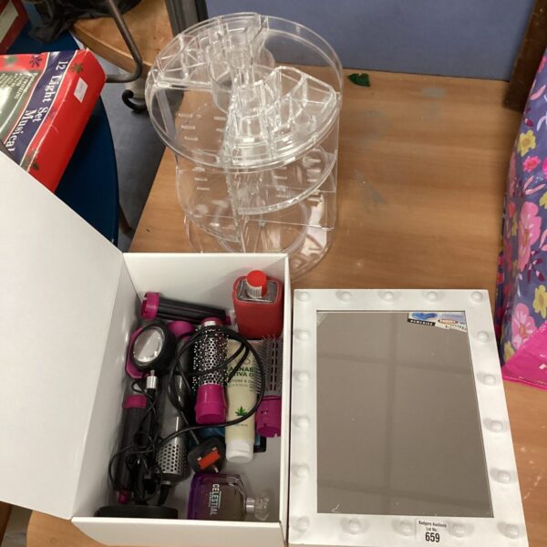 Makeup bundle with lighted mirror and cosmetic items.