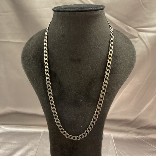 Close-up of a 925 silver curb chain necklace.