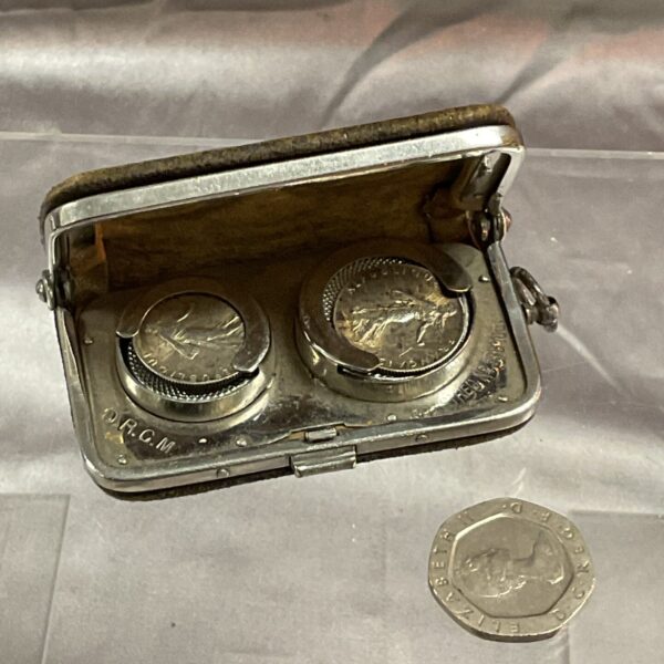 Vintage German leather coin purse with embossed detailing.