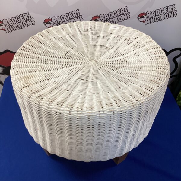 Vintage round wicker footstool for rustic home decor.