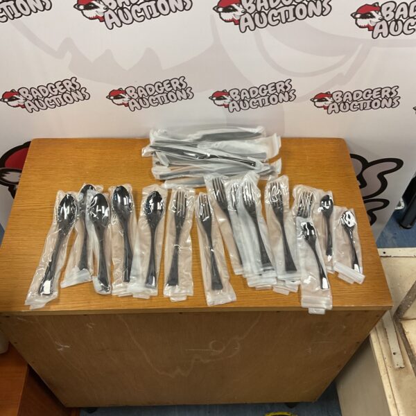 Boxed set of black handled stainless steel cutlery.