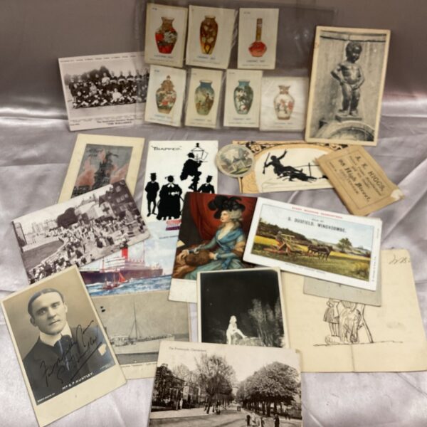 Vintage ephemera collection featuring postcards and cigarette silks.
