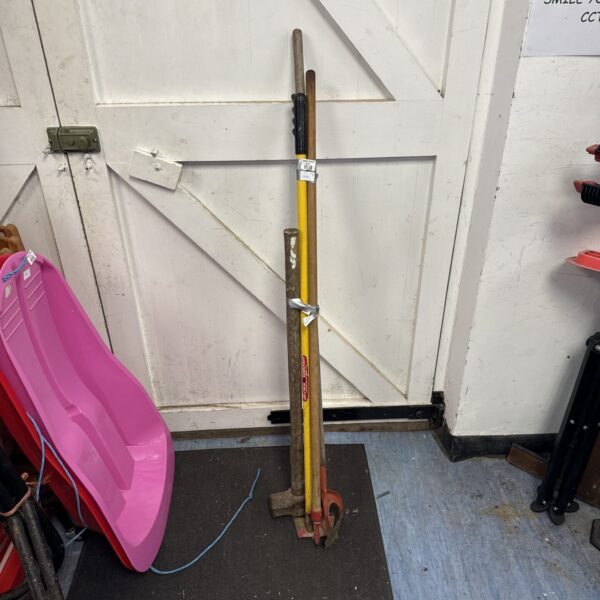Selection of vintage garden tools including a hoe and sledge hammer.
