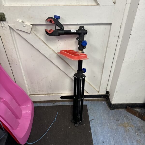 Black bicycle tripod service stand for bike repair and maintenance.