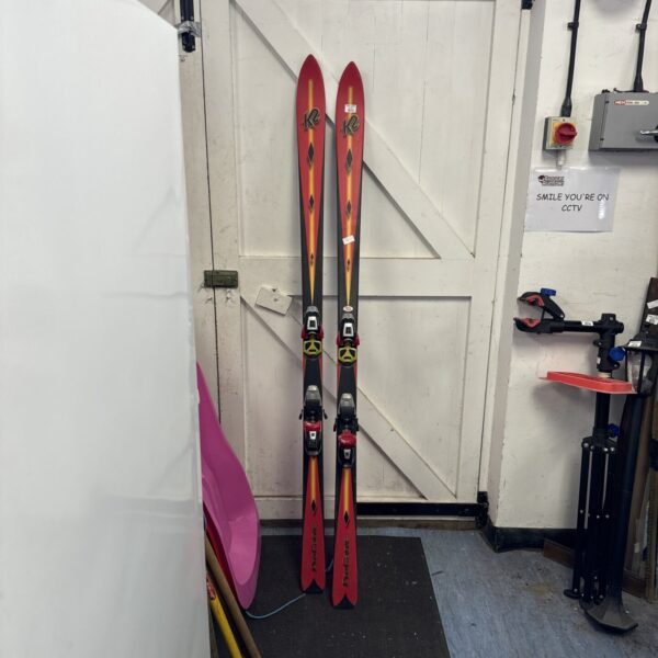 Red and black K2 Procarve skis for alpine carving.