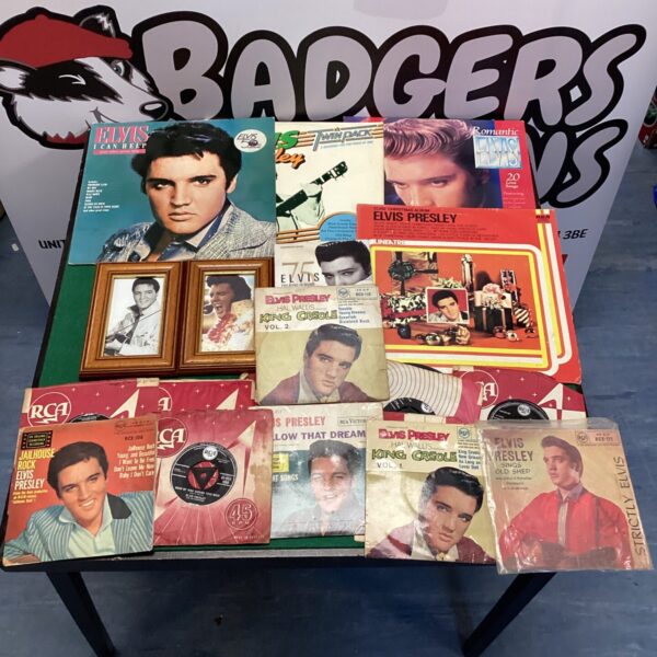 Elvis Presley collection featuring vinyl records, framed pictures, and CDs.