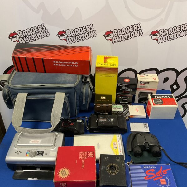 Vintage camera lot featuring a Kodak Brownie and telephoto lens.