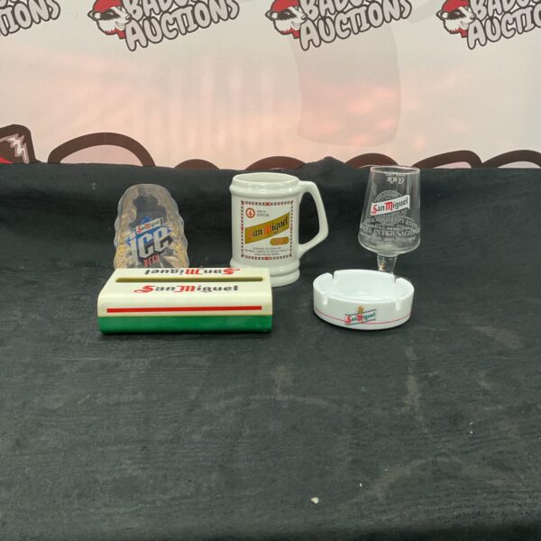 Sam Miguel branded items including a beer glass and promotional merchandise.