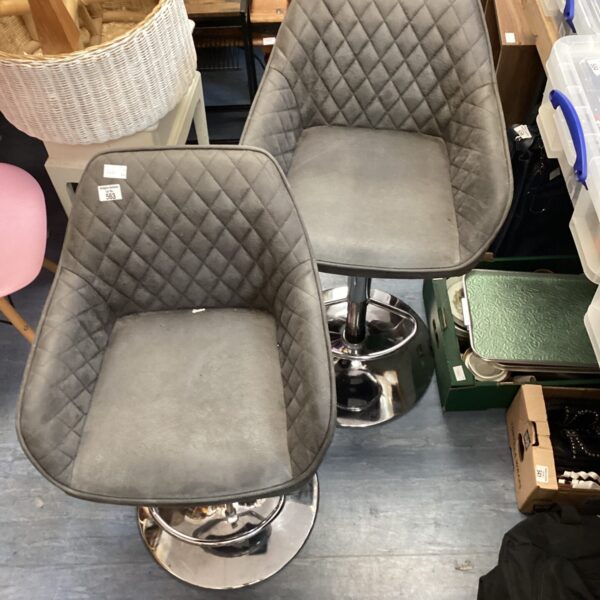 Pair of modern padded bar stools with chrome bases.