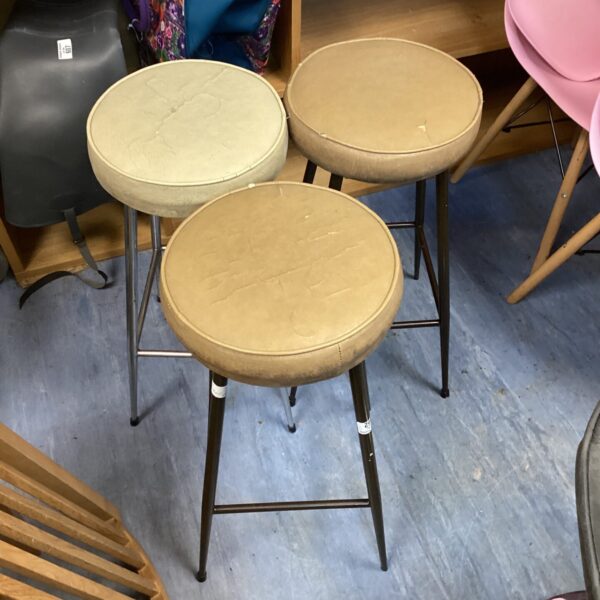 Vintage leather topped stools with wooden legs, mid century modern style.