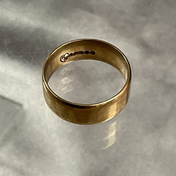 Close-up of a 9ct gold band ring, simple and elegant.