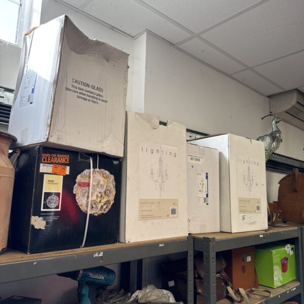 Stack of boxed ceiling lights, including BHS diamond cage light.