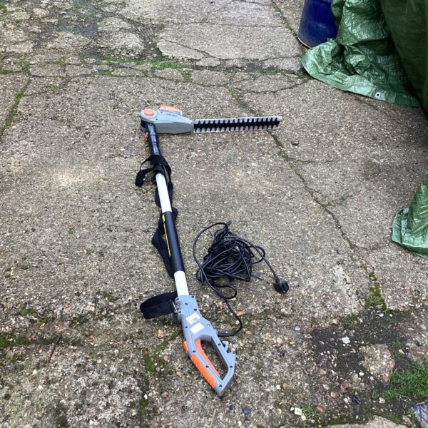 Terratek electric hedge trimmer with extending handle for garden use.