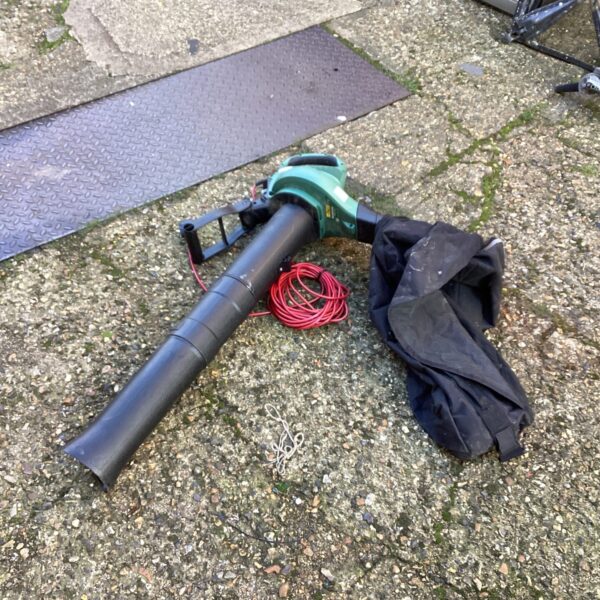 Bosch lawn vac and leaf blower in a garden setting.