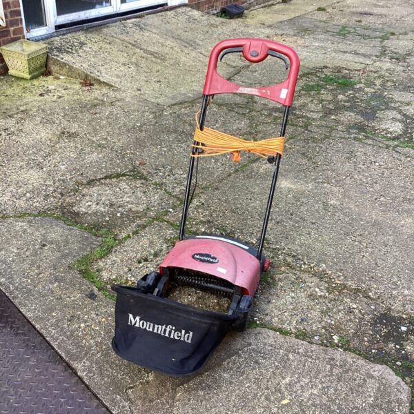 Used Mountfield electric scarifier for lawn care and garden maintenance.
